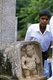 Sri Lanka: Boy with dwarf relief, Anuradhapura