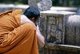 Sri Lanka: A monk taking a photo of a stone relief, Anuradhapura